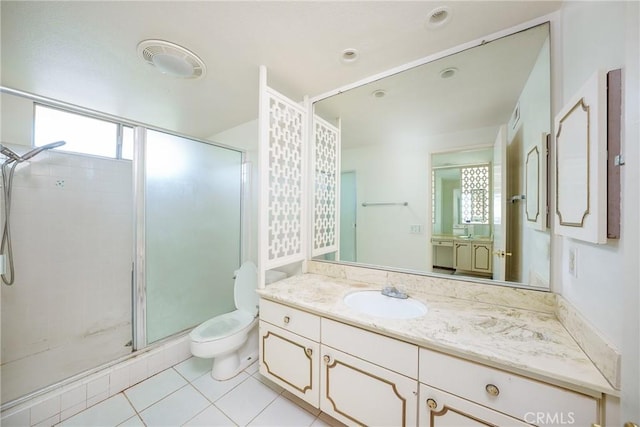 bathroom featuring tile patterned flooring, vanity, toilet, and walk in shower