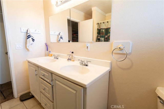 bathroom featuring vanity, ornamental molding, toilet, and tile patterned floors