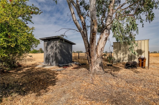 exterior space featuring a storage unit and a rural view