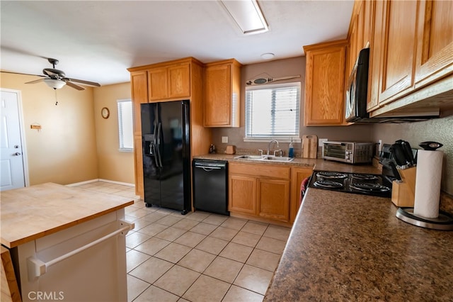 kitchen with sink, black appliances, light tile patterned floors, and ceiling fan