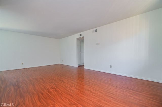 spare room with hardwood / wood-style floors