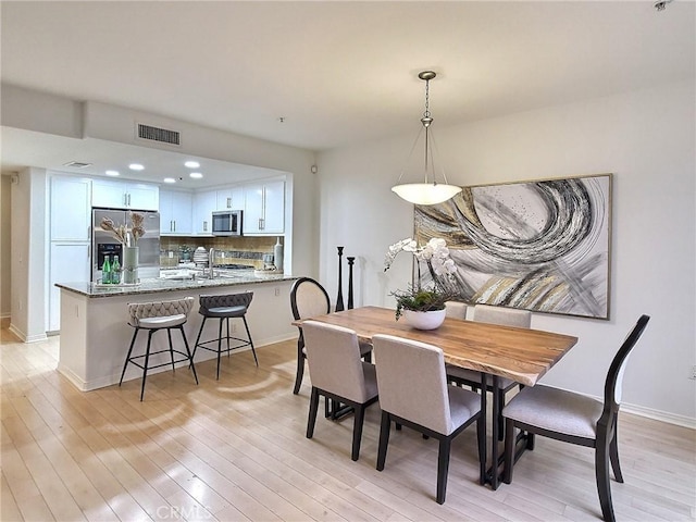 dining space with light wood-type flooring