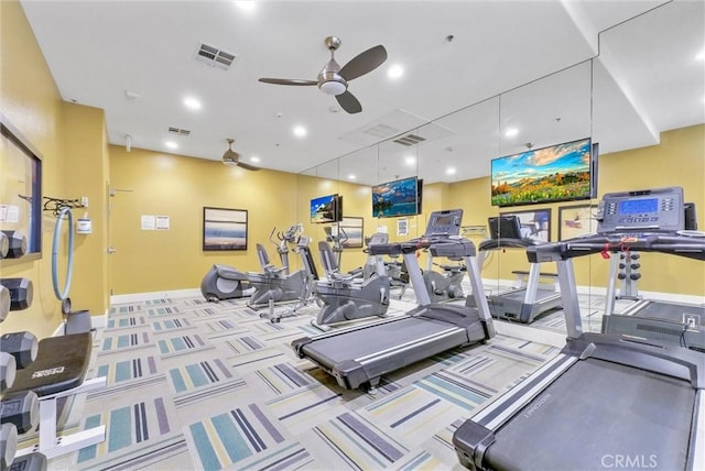 workout area with ceiling fan and light colored carpet