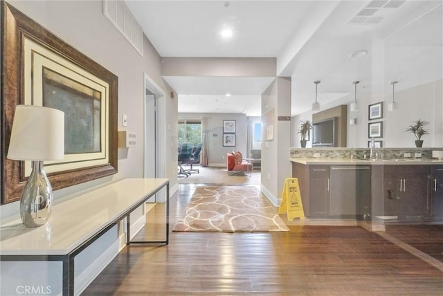 bathroom featuring vanity, wood-type flooring, and backsplash