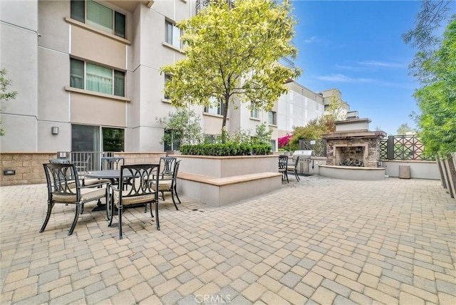 view of patio featuring an outdoor stone fireplace