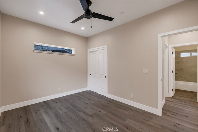 interior space with ceiling fan and dark hardwood / wood-style floors