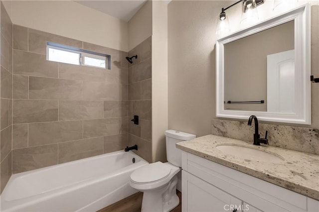 bathroom with vanity, shower / tub combination, and toilet
