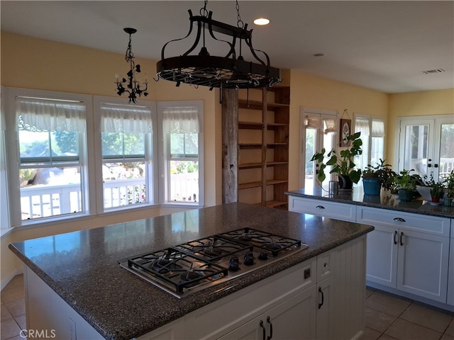 kitchen with white cabinetry, a chandelier, plenty of natural light, and stainless steel gas stovetop