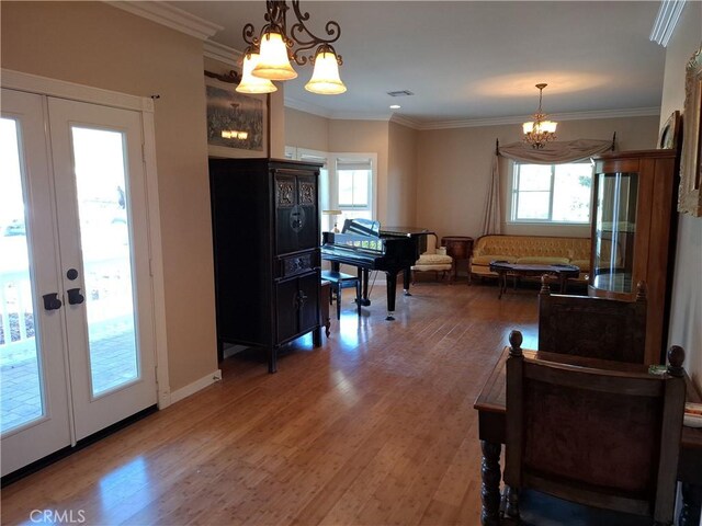 interior space with french doors, hardwood / wood-style flooring, and ornamental molding