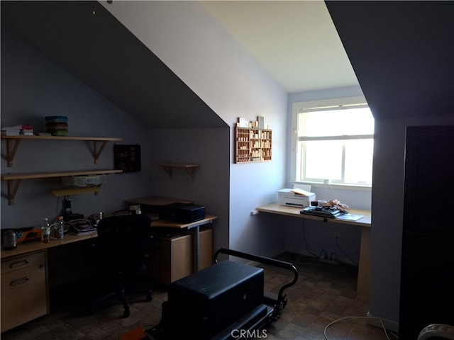 home office featuring lofted ceiling