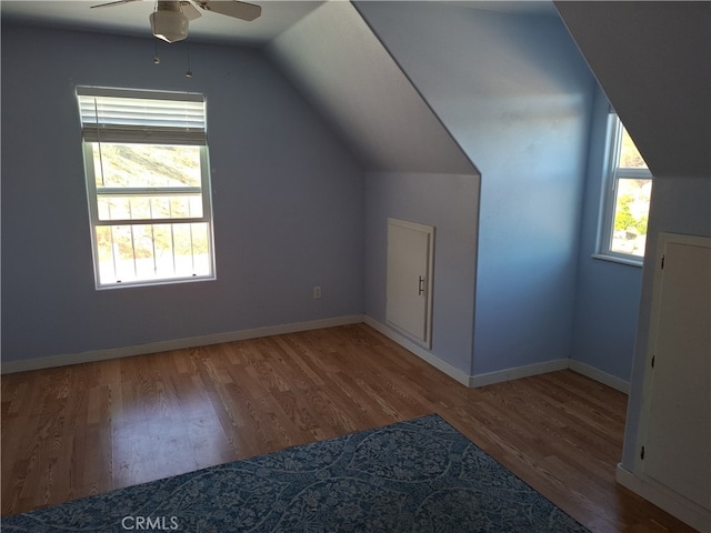 additional living space with ceiling fan, hardwood / wood-style flooring, and lofted ceiling