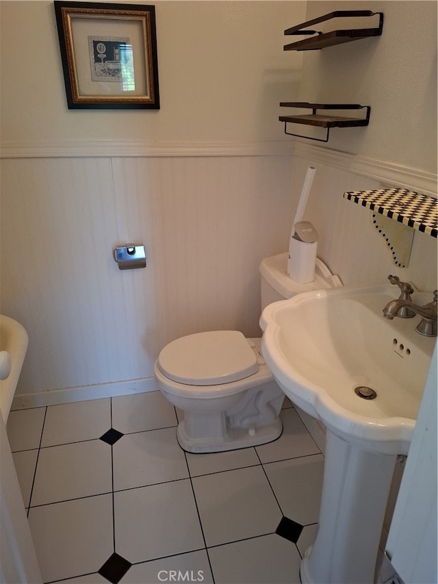 bathroom featuring toilet and tile patterned flooring