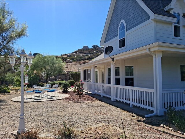 view of side of home with a porch