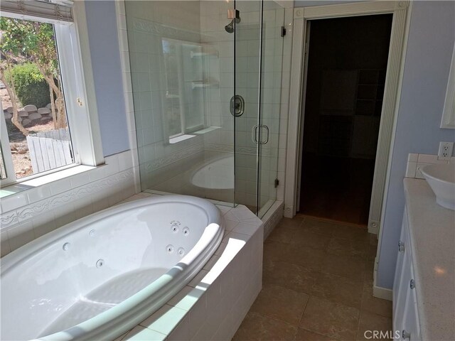 bathroom featuring vanity, independent shower and bath, tile patterned floors, and plenty of natural light