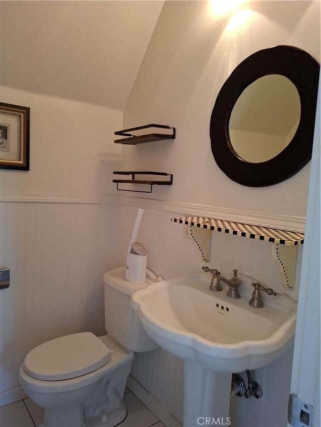 bathroom featuring toilet and tile patterned flooring