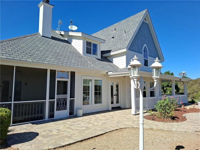 back of house featuring a sunroom and a patio area