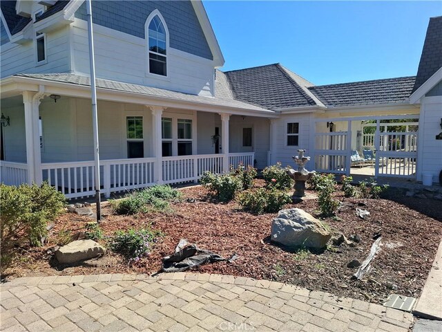 back of property with covered porch