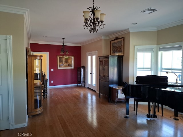 misc room featuring crown molding, a notable chandelier, and dark hardwood / wood-style floors