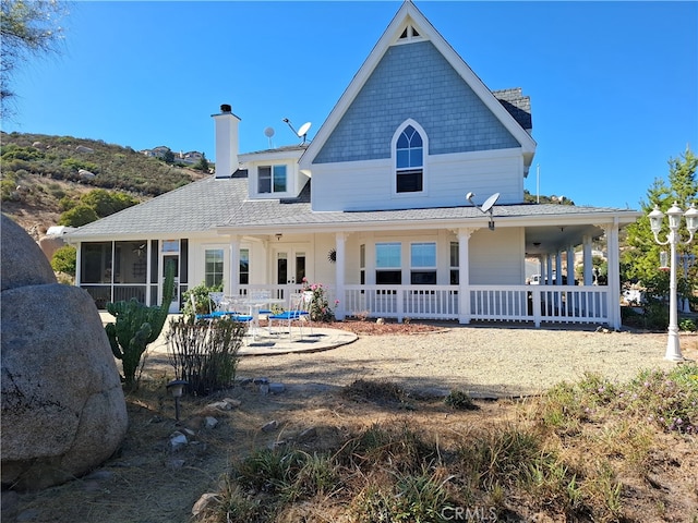 back of house featuring a porch