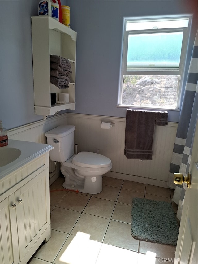 bathroom with vanity, toilet, and tile patterned flooring