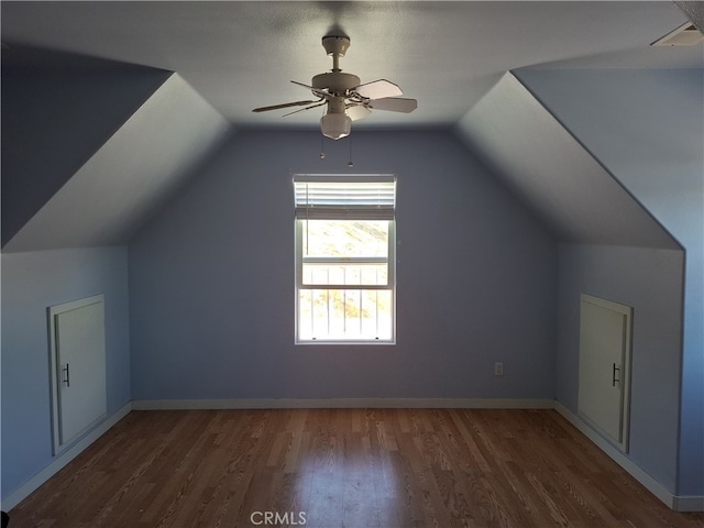 bonus room with lofted ceiling, a textured ceiling, ceiling fan, and dark hardwood / wood-style flooring