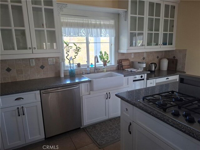 kitchen featuring stainless steel appliances, sink, and white cabinets