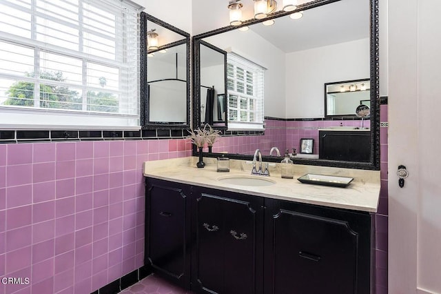 bathroom with vanity and tile walls