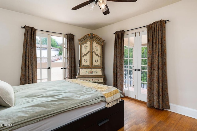 bedroom featuring access to exterior, french doors, wood-type flooring, and multiple windows