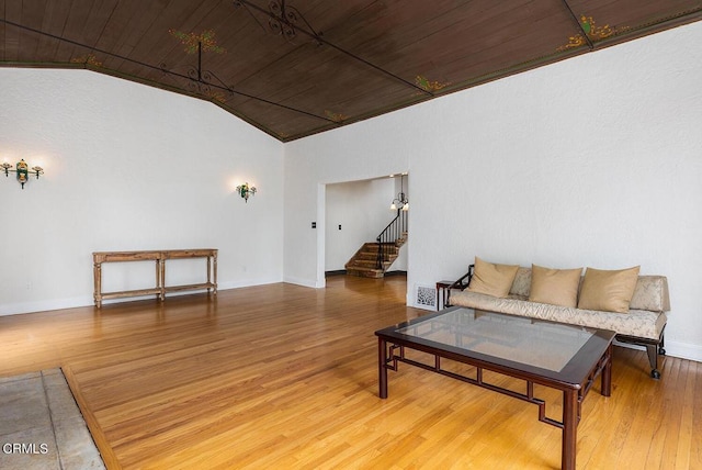 living room with hardwood / wood-style floors, wooden ceiling, and lofted ceiling