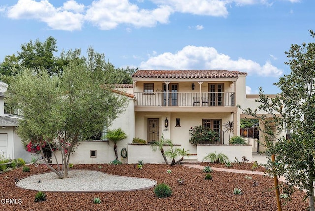 mediterranean / spanish house featuring a balcony