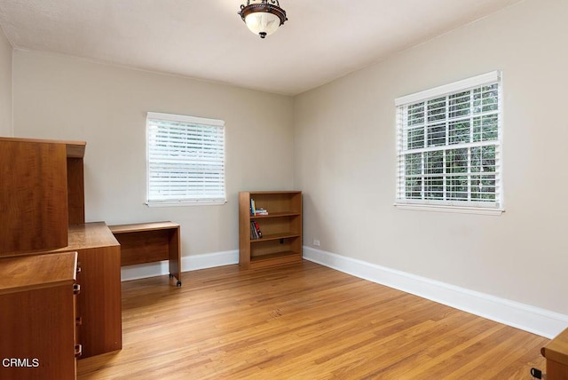 unfurnished room with light wood-type flooring