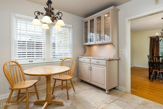 dining room featuring a wealth of natural light, light hardwood / wood-style flooring, and an inviting chandelier