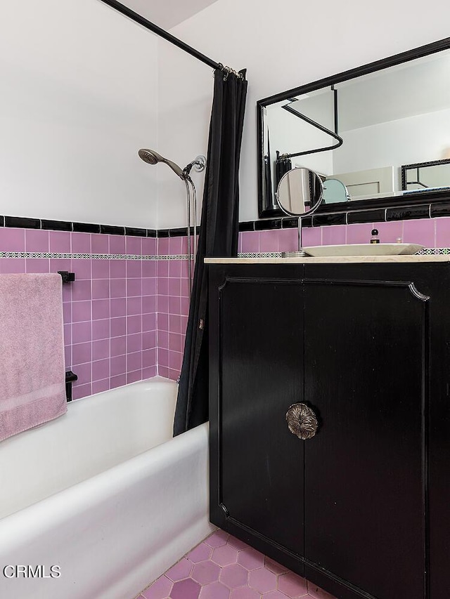 bathroom featuring vanity, shower / tub combo with curtain, and tile walls