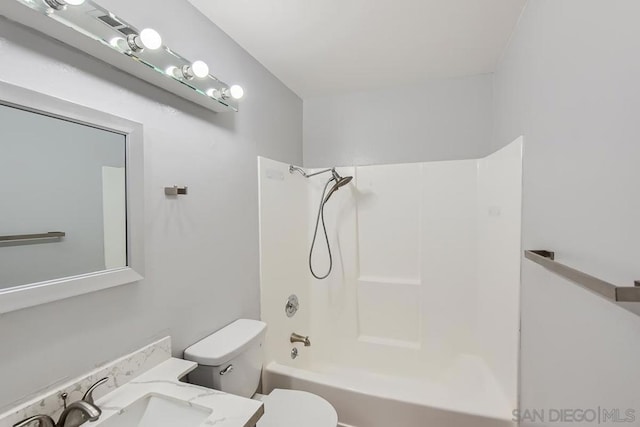 full bathroom featuring toilet, vanity, and tub / shower combination