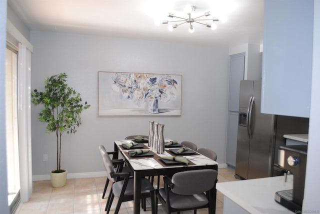 dining room featuring light tile patterned flooring and a chandelier