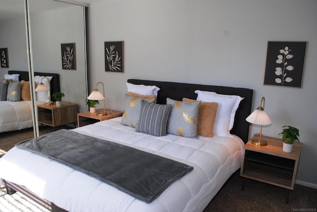 bedroom with a closet and dark colored carpet