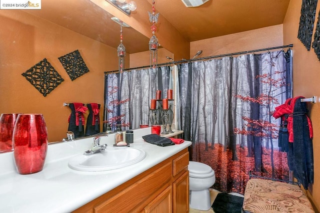 bathroom with walk in shower, vanity, and toilet