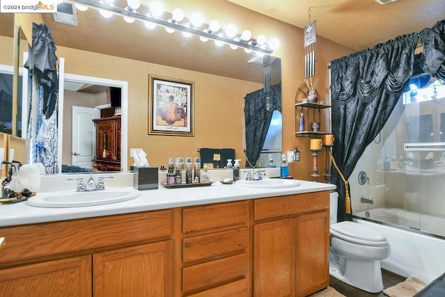 full bathroom with vanity, shower / bath combination with glass door, and toilet