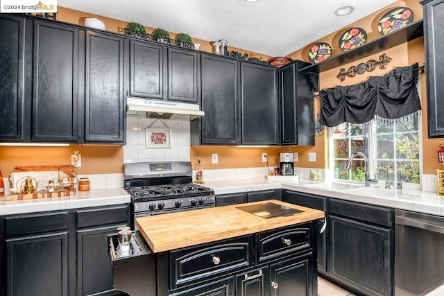 kitchen featuring appliances with stainless steel finishes, sink, and tile countertops