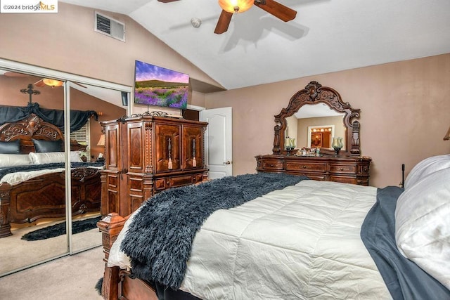 carpeted bedroom with lofted ceiling, ceiling fan, and a closet