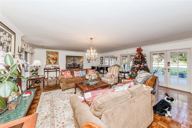 living room featuring ornamental molding, french doors, a notable chandelier, and light parquet flooring