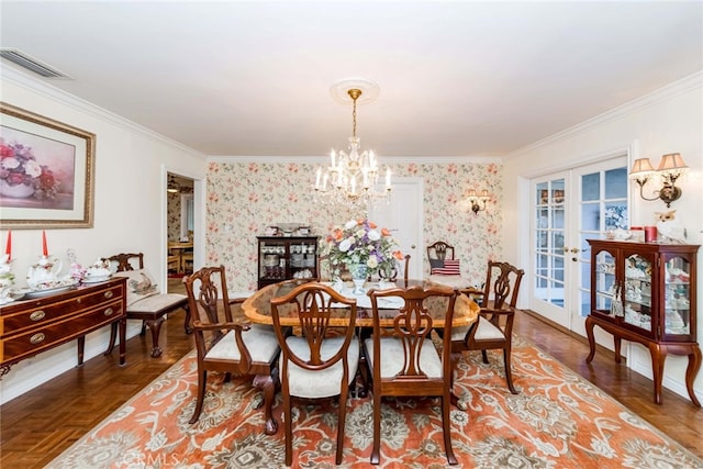 dining room with crown molding, parquet floors, a notable chandelier, and french doors