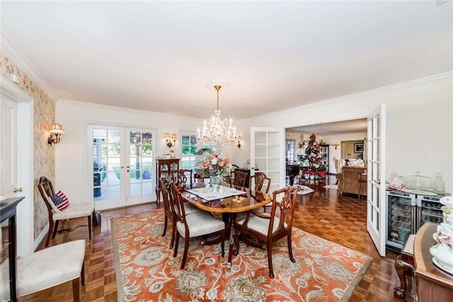 dining area with french doors, parquet flooring, wine cooler, crown molding, and an inviting chandelier