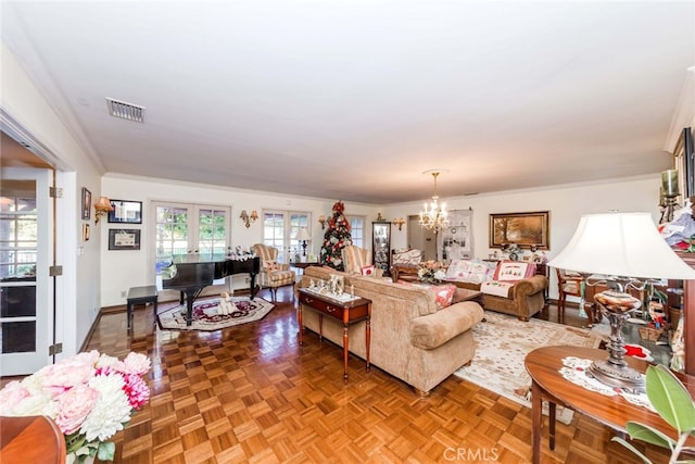 living room with french doors, parquet floors, a notable chandelier, and crown molding