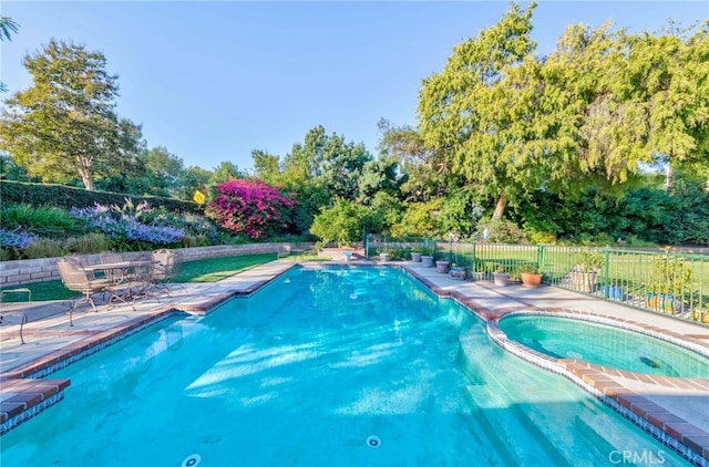 645 W Foothill Blvd, Arcadia, CA 91006 - view of swimming pool featuring a patio, view of wooded area, and a pool with connected hot tub