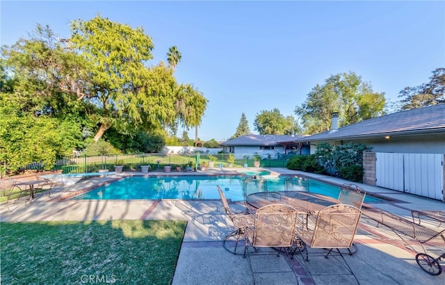 view of swimming pool featuring a yard and a patio area