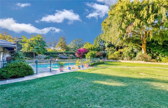 view of yard with a fenced in pool