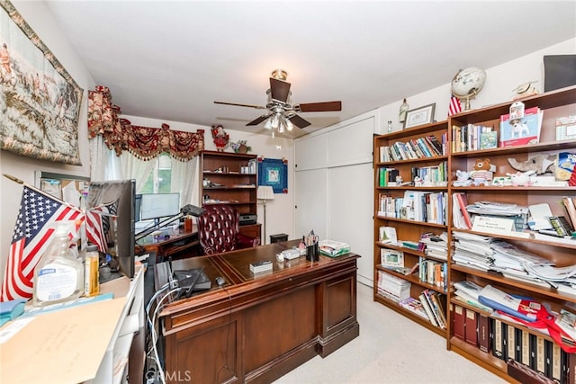 carpeted home office with ceiling fan