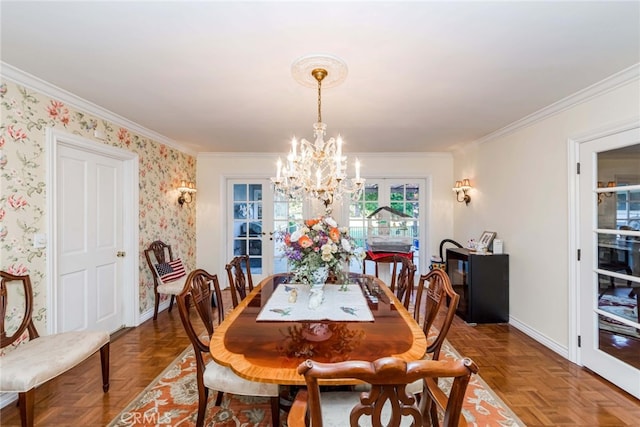 dining room with parquet flooring, ornamental molding, french doors, and an inviting chandelier