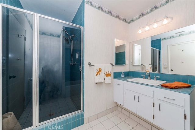 bathroom with vanity, walk in shower, and tile patterned flooring